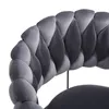 Close-up of a gray velvet chair with a braided design. Voir les images du produit