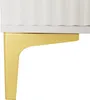 A close-up view of a white furniture piece with a fluted texture, supported by a gold-colored bracket. Anteprima dell’immagine prodotto