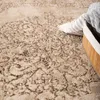 A close-up view of a rug with an abstract oriental pattern. Produktbild-Vorschau