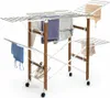 A foldable drying rack with clothes and shoes on it, set against a white background. Náhled obrázku produktu