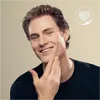A man is touching his chin and smiling, with a logo in the top right corner. Produktbild-Vorschau
