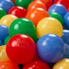 A close-up view of many colorful plastic balls, likely for a ball pit. Produktbild-Vorschau