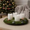 A Christmas advent wreath with four LED candles on a table, with a decorated Christmas tree in the background. Produktbild-Vorschau