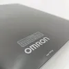 A close-up view of a black digital bathroom scale with branding and caution text. Podgląd zdjęcia produktu