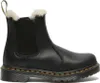 A black Dr. Martens boot with white fur lining. Produktbild-Vorschau