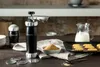A cookie press and ingredients are arranged on a wooden table, with cookies and milk in the background. Anteprima dell’immagine prodotto