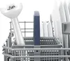 A close-up view of a hand blender attachment and plates in a dishwasher basket. Náhľad obrázku produktu