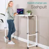 A woman is standing next to a mobile desk, using a laptop. Anteprima dell’immagine prodotto