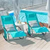 Two turquoise rocking lounge chairs are set up on a wooden deck next to a swimming pool. Náhled obrázku produktu