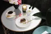 A table setting with coffee, cake, and flowers. Náhled obrázku produktu