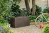 An outdoor storage box is shown in a garden setting next to a bicycle and a basketball. Podgląd zdjęcia produktu