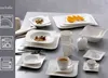 A collection of white porcelain dinnerware, including plates, bowls, cups, and a creamer, arranged on a table. Anteprima dell’immagine prodotto