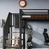 A close-up view of a black metal loft bed with wooden steps and a black office chair in the background. Anteprima dell’immagine prodotto