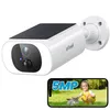 A white security camera with a solar panel on top is shown, with a smartphone displaying a child and a cat in the foreground. Náhled obrázku produktu