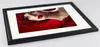 A framed picture of a woman with red flowers and makeup. Produktbild-Vorschau