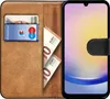 A book-style phone case with cards and cash inserted, shown open. Voir les images du produit