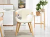A cream-colored dining chair with wooden legs is shown in a well-lit room. Produktbild-Vorschau