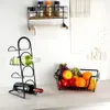 A kitchen counter with a wine rack, a fruit basket, and kitchen towels hanging on the wall. Anteprima dell’immagine prodotto