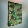 A folded camouflage tarp is shown against a gradient background. Anteprima dell’immagine prodotto