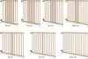 Multiple wooden baby gates of varying sizes are displayed side-by-side with measurements indicated. Produktbild-Vorschau
