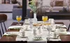 A table set for breakfast or brunch with plates, cups, glasses, and a vase of flowers. Náhľad obrázku produktu