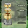 An exploded view of an alcohol stove and its components, set against a blurred background of trees and grass. Produktbild-Vorschau