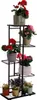 A multi-tiered metal plant stand filled with various potted flowering plants. Náhľad obrázku produktu