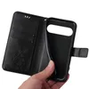 A hand holding a black flip phone case with a floral design. Produktbild-Vorschau