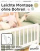 A baby and a child on a bed with a white bed guard. Produktbild-Vorschau