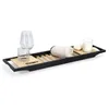 A bath caddy with various items on it, including glasses, a towel, soap, and a candle. Podgląd zdjęcia produktu