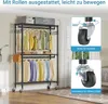 A black metal garment rack with two hanging rods and three shelves, loaded with clothes and boxes. The rack has wheels, and the image includes close-ups of the wheels highlighting their mobility and locking features. Text overlays provide information about Voir les images du produit