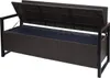 A poly-rattan storage bench with its lid open, revealing a dark blue cushion inside. The bench has a black metal frame. Náhled obrázku produktu