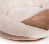 A close-up view of a soft, plush dog bed with cream and brown sections. Produktbild-Vorschau