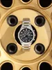 A silver Casio Edifice watch is placed on a gold-colored wheel rim. Produktbild-Vorschau