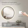 A round LED mirror with a black frame is shown, reflecting a bathroom interior. Text overlays describe features like wall switch compatibility and power failure memory function. A hand is shown interacting with a wall switch. Podgląd zdjęcia produktu