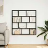 A black, multi-compartment wall shelf filled with books and decorative items, mounted on a white wall next to a sofa and a large potted plant. Podgląd zdjęcia produktu