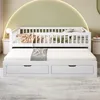 A white wooden daybed with a pull-out trundle and two drawers, set against a light green arched wall. Produktbild-Vorschau