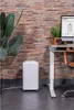 A white Eurom dehumidifier is placed on the floor next to a desk with a computer monitor displaying product information. Voir les images du produit