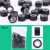 A collection of black hair extension rings and a bag of the same rings. Náhľad obrázku produktu