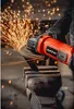 A person wearing gloves is using an angle grinder to cut metal, creating a shower of sparks. Podgląd zdjęcia produktu