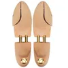 A pair of wooden shoe trees with gold accents, presented against a white background. Náhľad obrázku produktu
