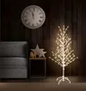 A living room scene with a couch, a side table with decorations, and a lit LED tree. Produktbild-Vorschau