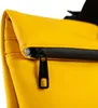 A close-up of a yellow backpack's zipper. Produktbild-Vorschau