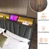 A close-up view of a bed's headboard with integrated LED lighting and decorative elements. Voir les images du produit