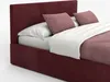 A close-up view of a burgundy upholstered bed with white bedding and pink decorative pillows. Podgląd zdjęcia produktu