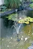 A solar-powered fountain operating in a pond with lily pads. Produktbild-Vorschau