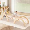 Two children playing on a wooden climbing structure in a room with a large window. Produktbild-Vorschau