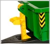 A close-up view of the mechanism of a green toy container with yellow accents. Produktbild-Vorschau