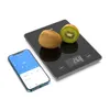 A digital kitchen scale with two kiwis on top, next to a smartphone displaying a nutrition app. Náhľad obrázku produktu