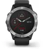 A close-up studio shot of a Garmin Fenix 6 smartwatch with a black band and silver bezel, displaying its watch face with various health and time metrics. Produktbild-Vorschau